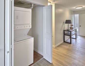 a white washer and dryer in a room with a hallway and a door  at 3030 Lake City, Seattle, WA, 98125